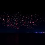 Bali drone light show over the ocean at night.