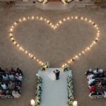 Aerial wedding ceremony with drone heart formation.